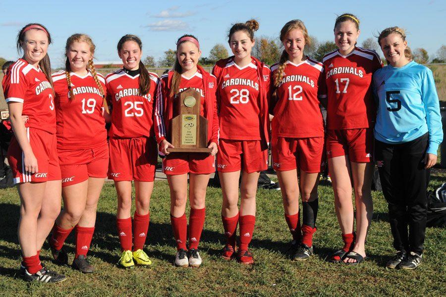 Soccer seniors pose with regional championship trophy.