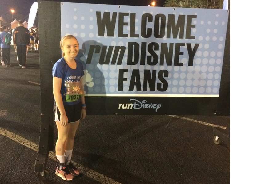 Julia Graves stands by the Welcome Sign in Disney World.