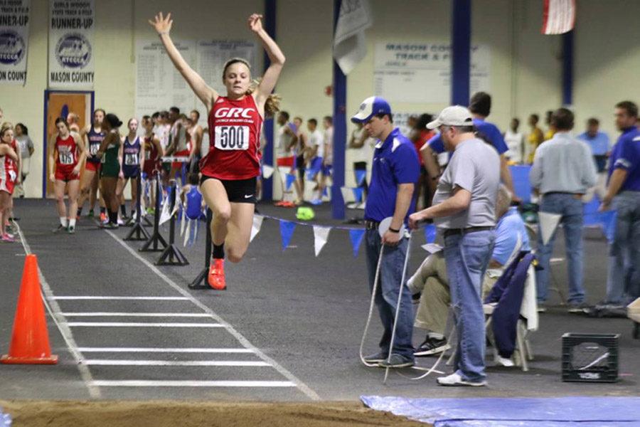 Makenzie Cooper performs her long jump.