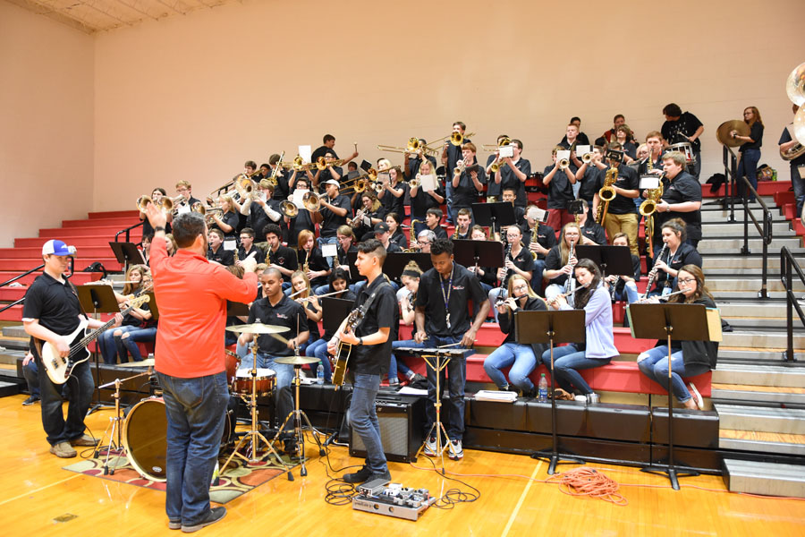 Mr. Payne directs the pep band during a basketball game.