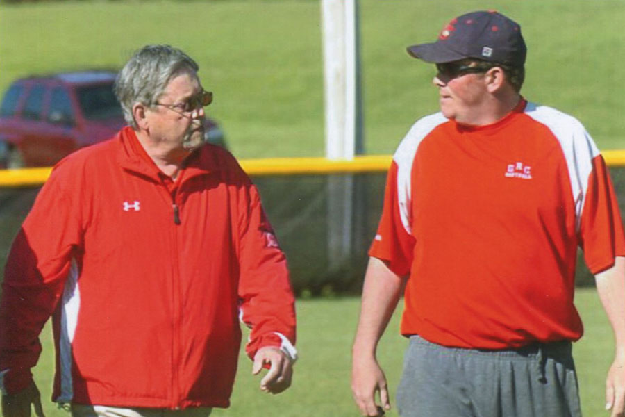 The late Jerry Puckett discusses strategy before game with son and GRC head coach Matt Puckett.