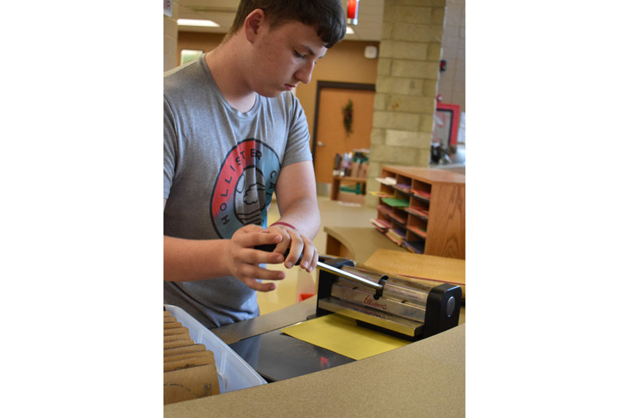 Jared Howard, 11th, uses the letter cutter in the Makerspace for a class project.