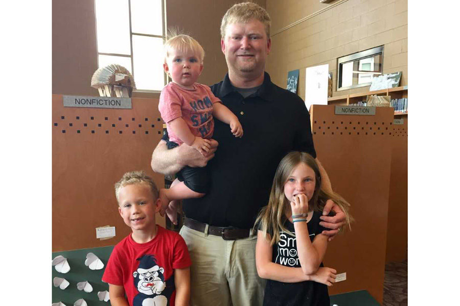 Coach Rogers posing with his kids.