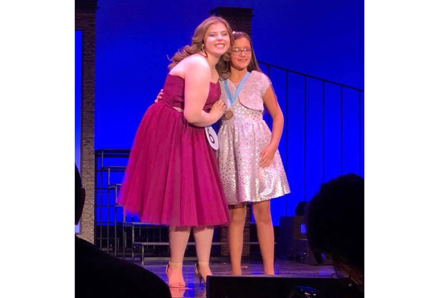 Caroline Handshoe on stage with her little sister Janeway Lowther