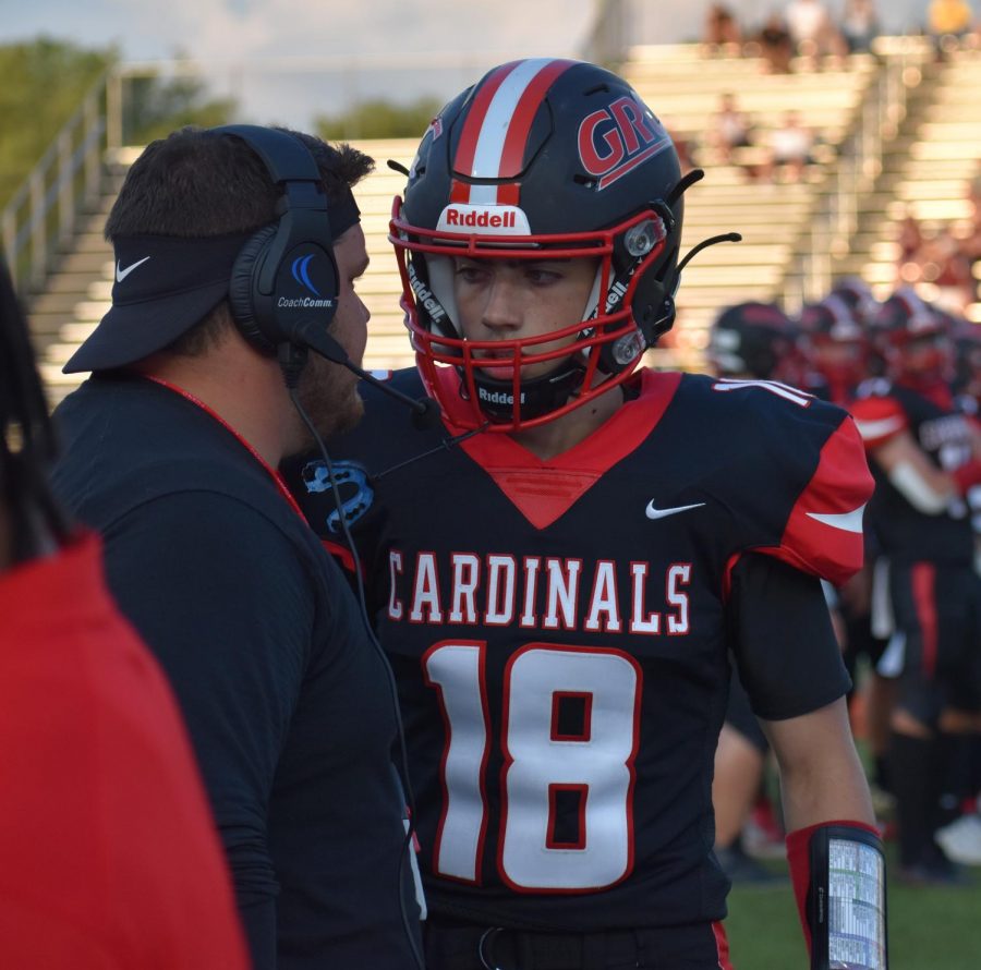 QB Brady Denham strategizes with Coach Ray at the Cards first home game.