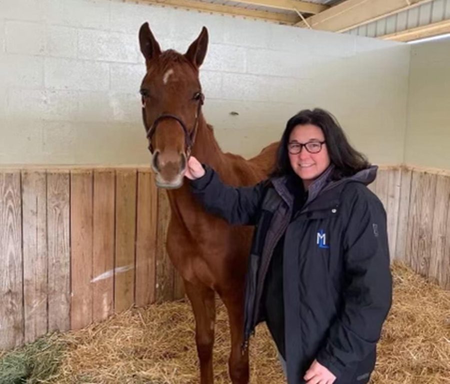 Mary poses with a weanling filly she purchased at the Ocala Breeders Sale. He horse, named To a T, is still racing and has made almost $300,000 in purse earnings.