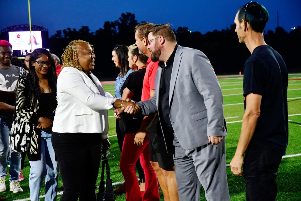 Maisha Thomas Jack, a 2023 CCPS Hall of Fame inductee, is congratulated by Superintendent Dustin Howard at Cardinal Stadium last year. The 2024 Class will be inducted Friday night.