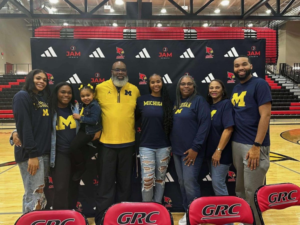 Ciara Byars celebrates with her famiily after signing to continue her athletic and academic career at the University of Michigan.